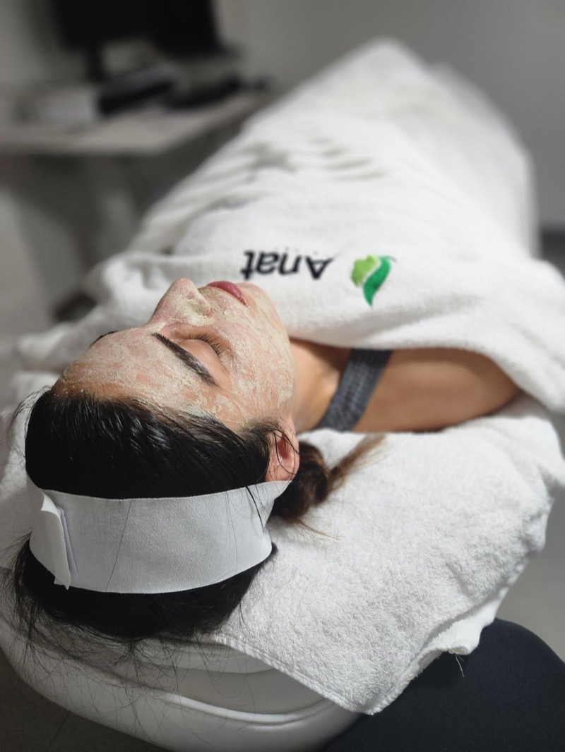 Exfoliating mask during facial treatment