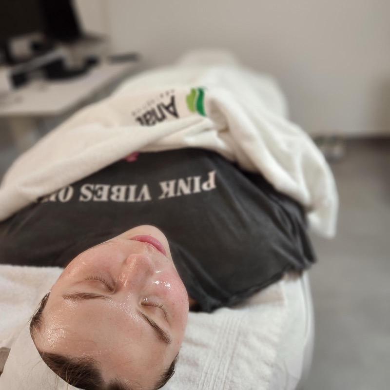 Client relaxing after facial treatment with glowing results